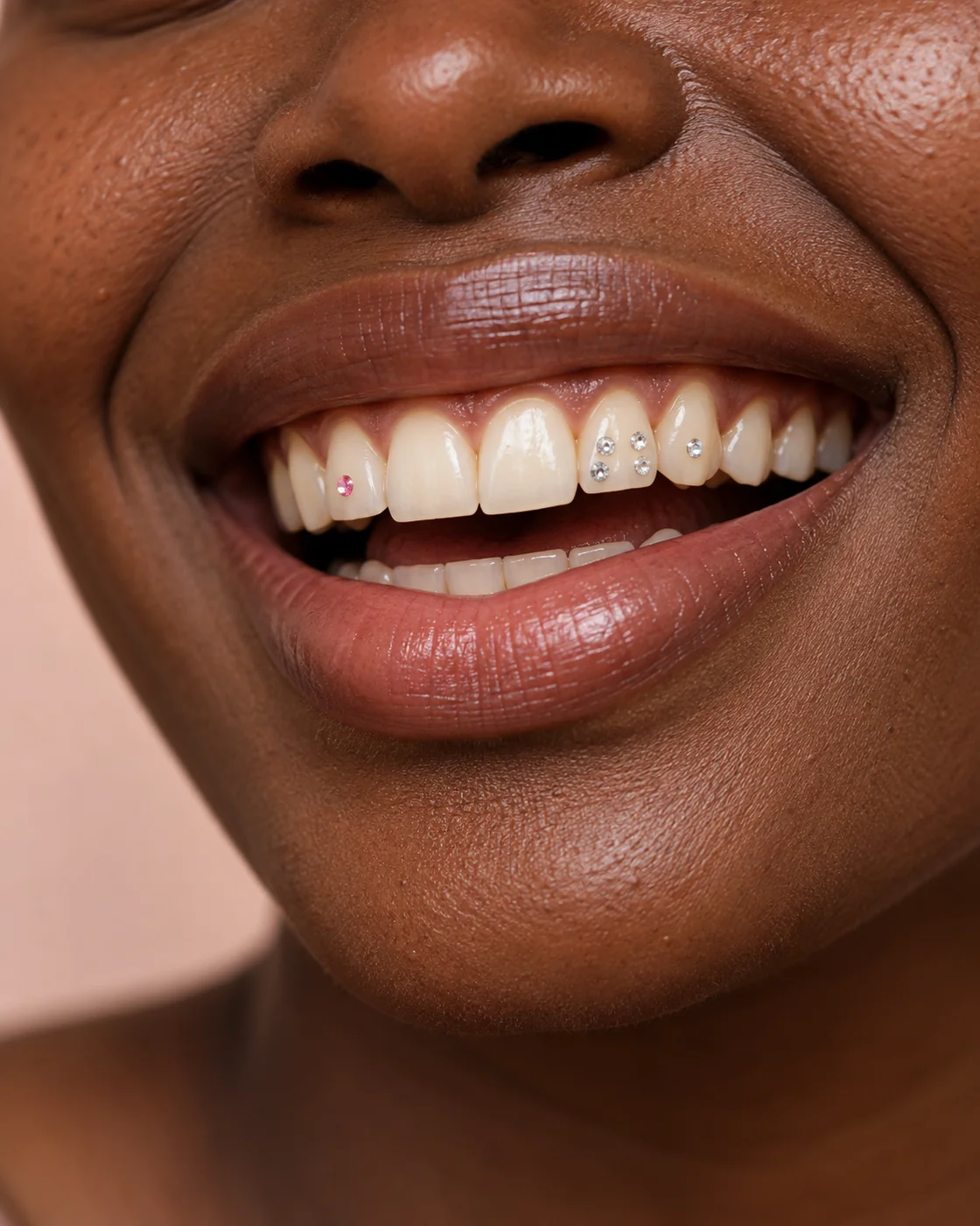 A joyful smile with a cluster of clear crystals and a small pink gem.